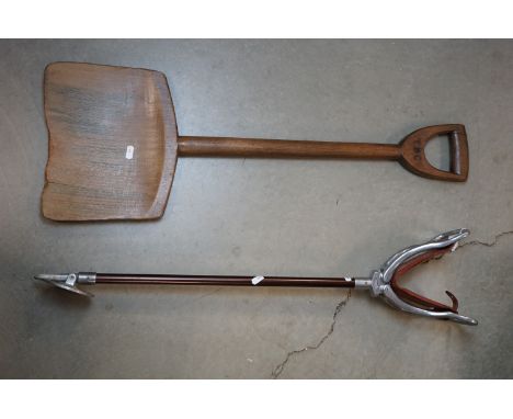 A vintage shooting stick together with a wooden shovel marked T.B. Co. 
