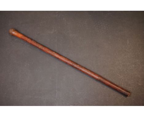 An oriental carved bamboo walking stick cane. 