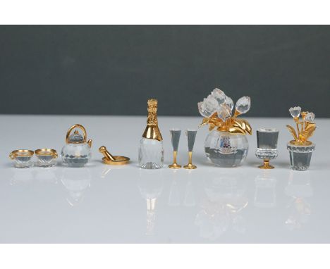 Nine Swarovski Crystal miniatures, comprising champagne bottle, two champagne flutes, teapot with two cups and saucers, wine 