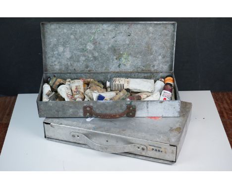 A collection of vintage oil paints contained in aluminium cases. 