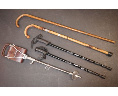 A collection of five sticks to include a Swaine silver banded walking stick (London 1921), a shooting stick, two wooden walki