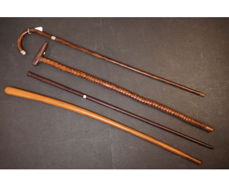 A collection of four vintage wooden walking sticks to include a silver collard example. 