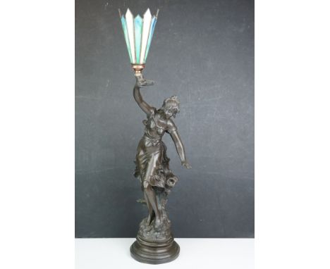 A vintage cast metal lamp of an art nouveau lady, indistinctly signed. 