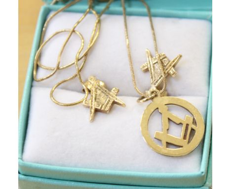 A pair of 9ct gold Masonic earrings, 1.8g in total, another single Masonic earring and a matching pendant on gold coloured ch