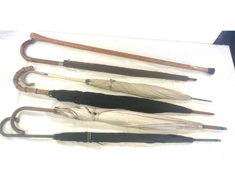 Large selection of vintage umbrellas and a walking stick 