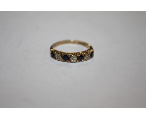 A HALLMARKED 9 CARAT GOLD SEVEN STONE DRESS RING SET WITH BLUE AND CLEAR STONE