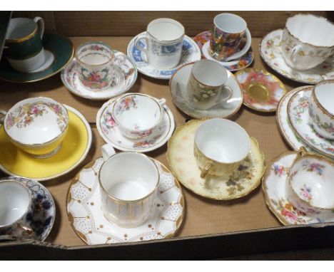 A TRAY OF ANTIQUE AND LATER CUPS AND SAUCERS TO INCLUDE ADDERLEY, COALPORT AND LIMOGES EXAMPLES