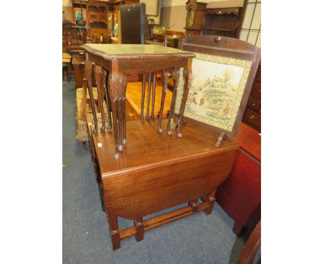 A HEAVY OAK DROPLEAF TABLE WITH AN OAK FRAMED FIRESCREEN AND A GLASS TOPED NEST OF TABLES (3)