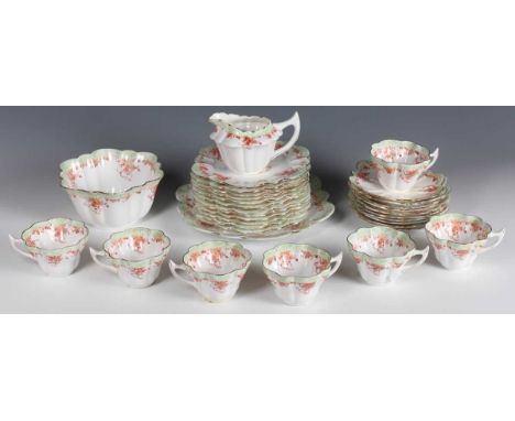 A Wileman &amp; Co The Foley China part tea service, early 20th century, printed in orange and green with pendant flowers, of