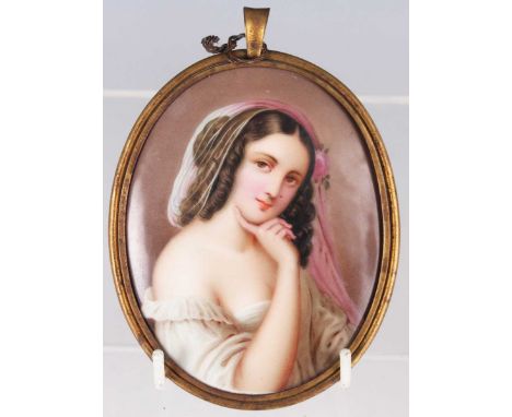 A Continental porcelain oval plaque, late 19th century, painted with a half length portrait of a young girl wearing a white d