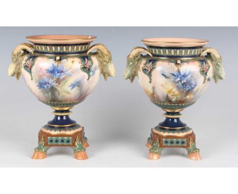 A pair of Hadley's Worcester vases, circa 1900, painted with cornflowers and buttercups within enamelled scroll moulded frami