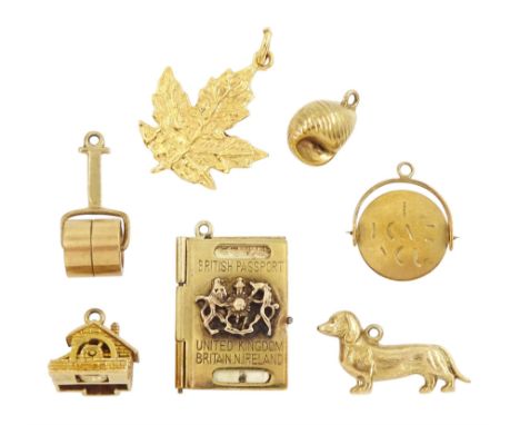 Six 9ct gold pendant / charms including British passport by Georg Jensen, garden roller, dachshund, shell, watermill and I lo