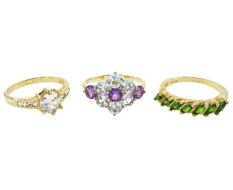 Three 9ct gold rings including amethyst and blue topaz flower head cluster, white topaz and a marquise cut garnet half eterni