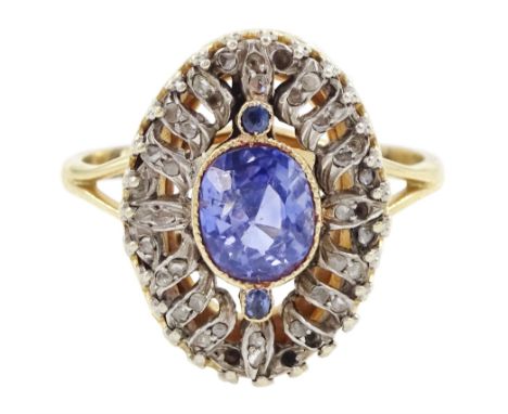 Early 20th century gold and silver sapphire and diamond chip open work cluster ring, the principal oval cut sapphire of appro