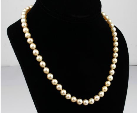 A single strand cultured pearl necklace - with 7mm. pearls and hallmarked 9ct gold bright cut clasp, 44.5cm. long.
