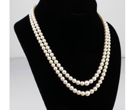 A vintage double-strand cultured pearl necklace - 1960s, the pearls graduating from 7.5mm. to 4mm. diameter, with a 9ct gold 