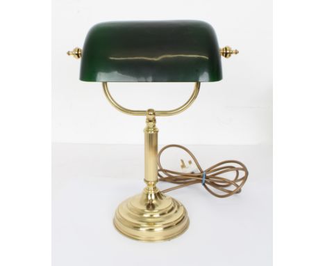 An antique style brass and green glass library lamp - the adjustable dark green cased shade on a fluted column to a stepped c