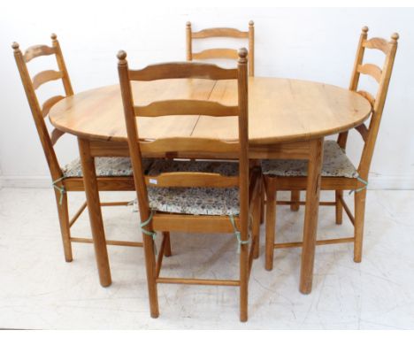 An Ercol oval-topped extending pine dining table on turned legs, together with a set of four ladderback chairs (LWH 187 exten