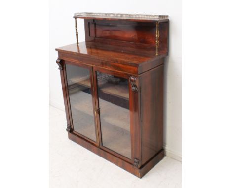 A late Regency rosewood chiffonier - the panelled top with single shelf with gilt brass lancet gallery, on turned gilt brass 