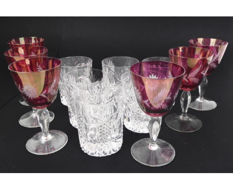 A set of six red overlay wine glasses and&nbsp;six heavily cut whisky tumblers.