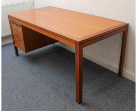A 1970s-80s teak modernist style desk - probably Scandinavian, the cleated, rectangular top over a single bank of drawers to 