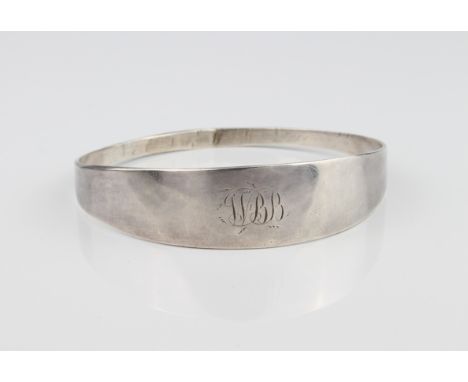 A Victorian silver bangle - hallmarked London 1860, plain form with engraved monogram, internal diameter 6.7 x 6.5mm.