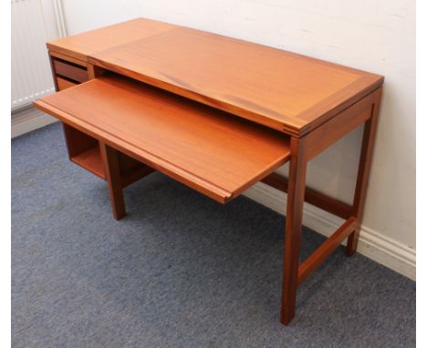 An early 1980s teak modernist style student's or computer desk - the rectangular, cleated top over a sliding writing surface 