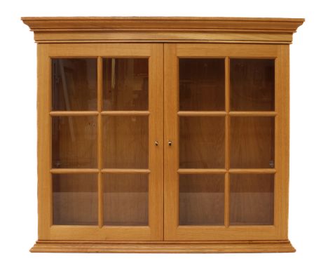 A light-oak glazed wall hanging cabinet or bookcase - believed to be by&nbsp;Thomas Hudson (the 'Cowman') of Odell, Bedfordsh