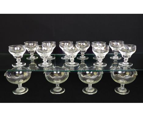 A set of eleven crystal champagne saucers; together with a set of four glass sweetmeat dishes with wavy rims. (15)