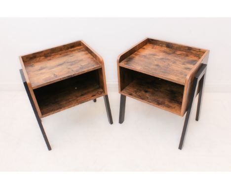 A pair of modern two-tier bedside tables: the tops with three quarter galleries over an open lower shelf, on angular ebonised