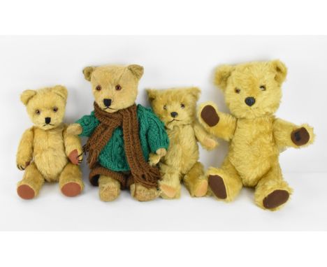 A small collection of Chiltern teddy bears, all in blonde hair, to include one with knitted clothing, two with plastic noses,