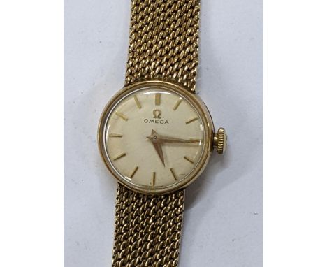 A Omega manual wind ladies 9ct gold wristwatch, circa 1961, having a white enamel dial with gilt baton markers, Omega crown, 