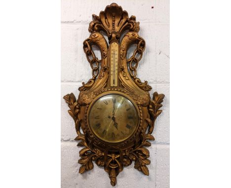 A mid 20th century French Louis XVI style wall hanging clock, the carved gilt wood case having a shell shaped finial above bi