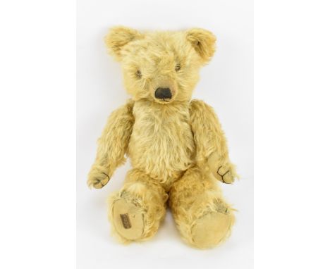 A rare 1930s Merrythought magnet teddy bear, in blonde wool plush, with brown stitched nose, paws and feet, orange and brown 