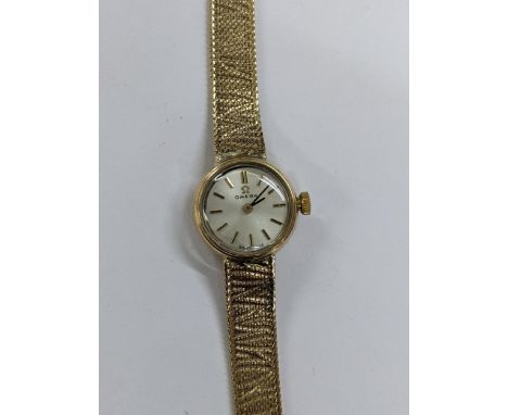 An Omega manual wind, ladies 9ct gold wristwatch, circa 1966, having a silvered dial with baton markers, 9ct gold bracelet an