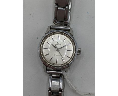 An Omega Geneve, ladies, stainless steel, manual wind wristwatch, having a silvered dial with centre seconds and baton hour m