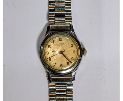 A vintage Longines manual wind, gents, stainless steel wristwatch, having a cream dial signed Longines Fab Suisse, with centr