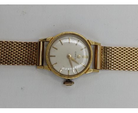 A Omega manual wind ladies 18ct gold wristwatch, circa 1961, having a white enamel dial with gilt baton markers, Omega crown,