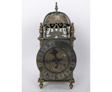 An early 20th century brass lantern clock, in the 18th century style the four post case with 5" dial applied with Roman numer