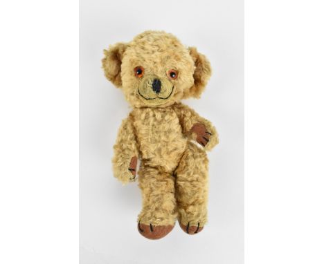 A Merrythought 'Cheeky' teddy bear, in light mohair, jointed, with stitched nose, hands and feet, glass eyes, with rattling b