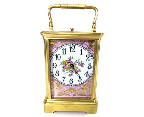 An early 20th century repeater carriage clock, having Sevres style porcelain panels decorated with cherubs and floral motifs,