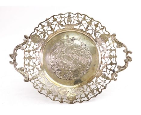 An ornate Dutch silver shaped circular two-handled dish, English import marks for 1891, the centre embossed with a sporting s