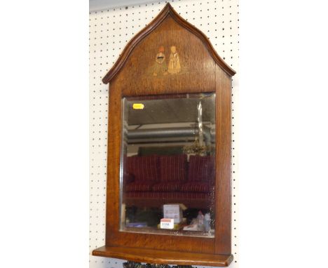 A Dutch early 20th century oak bevelled wall mirror, the lancet arched top inlaid with figures, 65 x 35cm