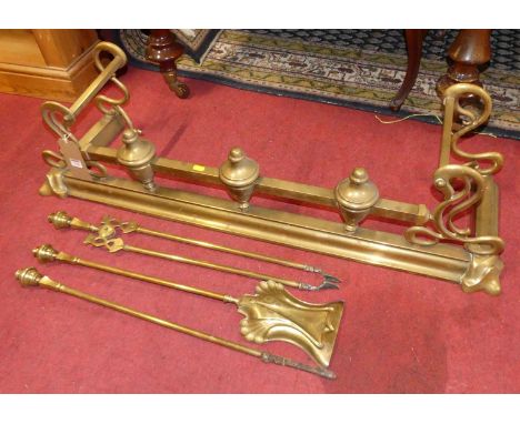 A late Victorian brass fire fender, together with sundry fire tools to include; shovel, poker and tongs (4)
