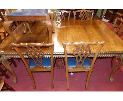 An early 20th century mahogany round cornered rectangular dining table, having gadrooned edge, raised on acanthus leaf cabrio