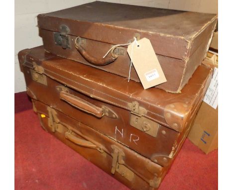 Three various vintage faux leather suitcases, the largest width 59cm