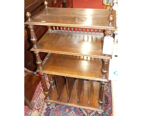 A late Victorian walnut and gilt decorated three-tier Canterbury whatnot, having fluted and turned columns, over divisional l