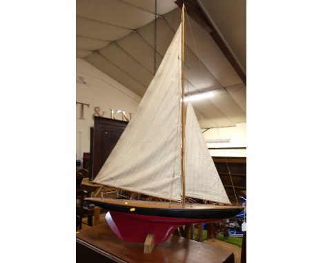 A scratch-built model pond yacht, with sail, titled Britannia, length 90cm
