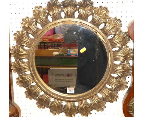 A contemporary circular wall mirror, with repeating leaf decorated surround, dia.52cm 