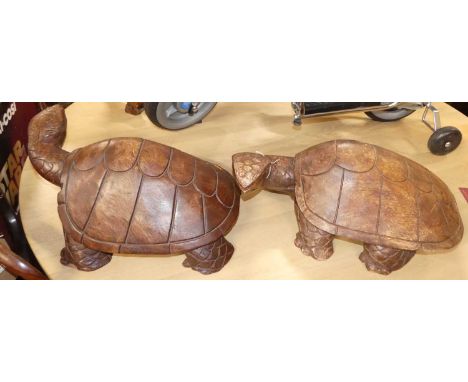 A pair of contemporary carved hardwood model turtles, each length 53cm 